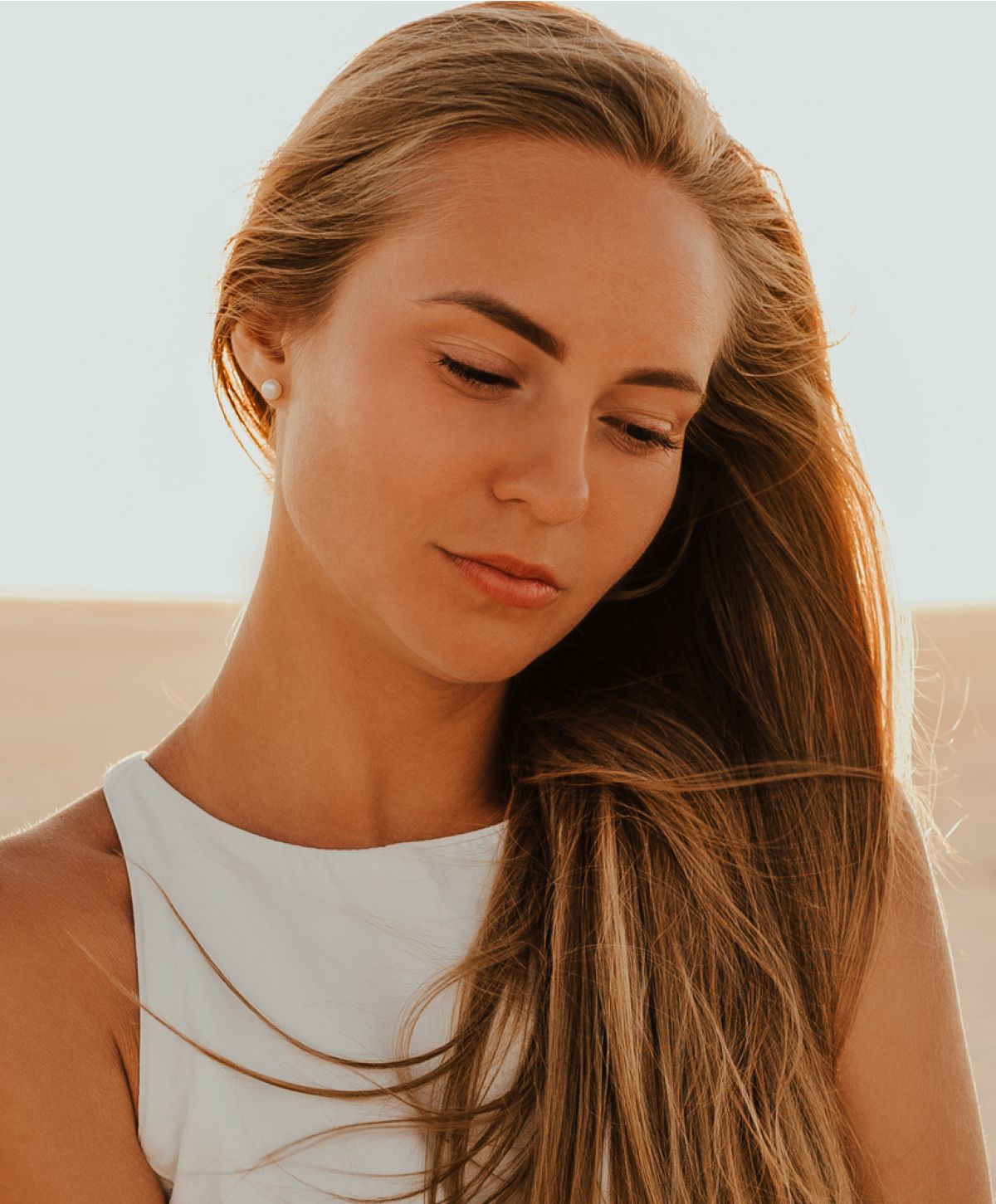 Woman with flowing hair in natural light.