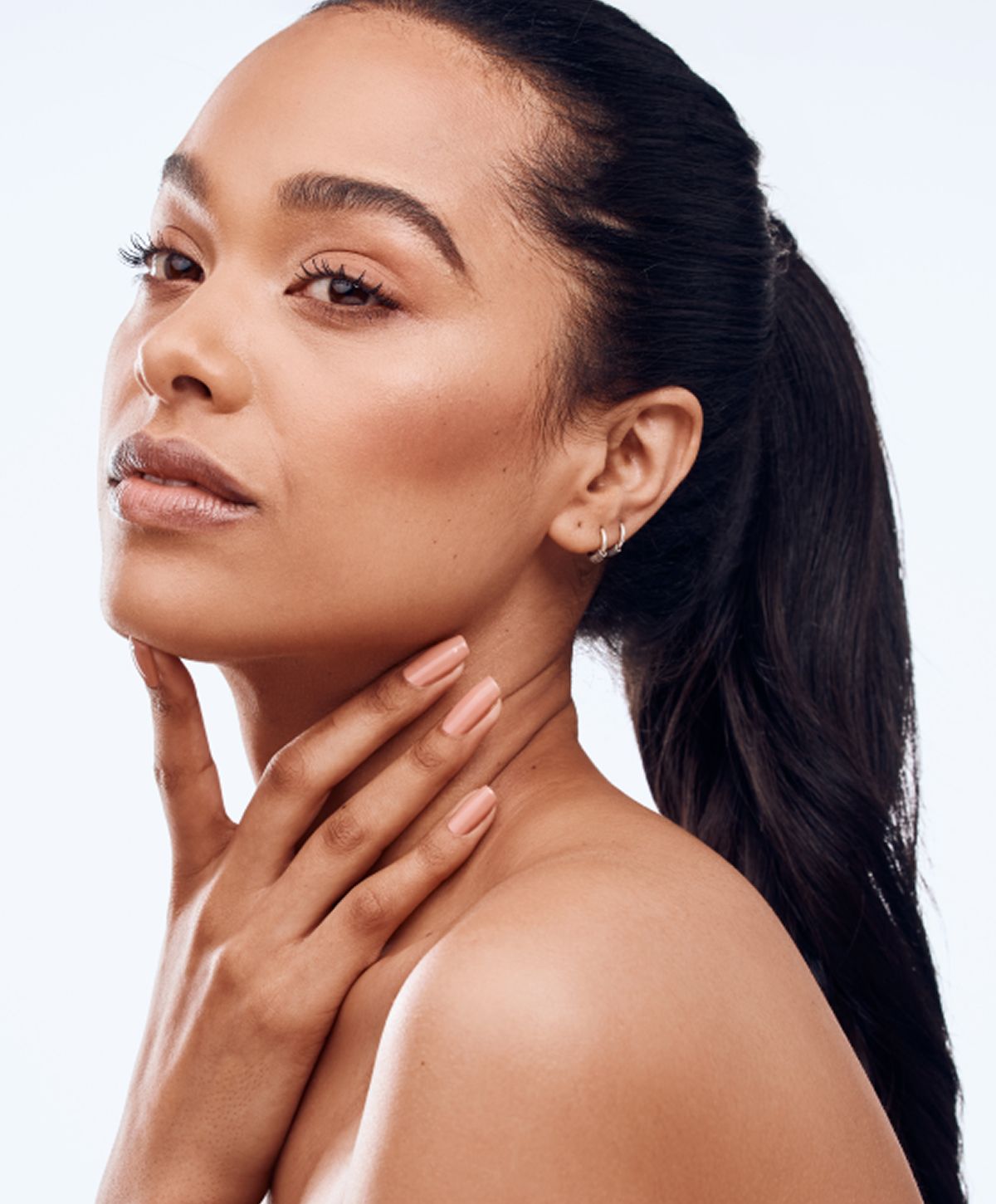 Portrait of woman with long hair and nails.