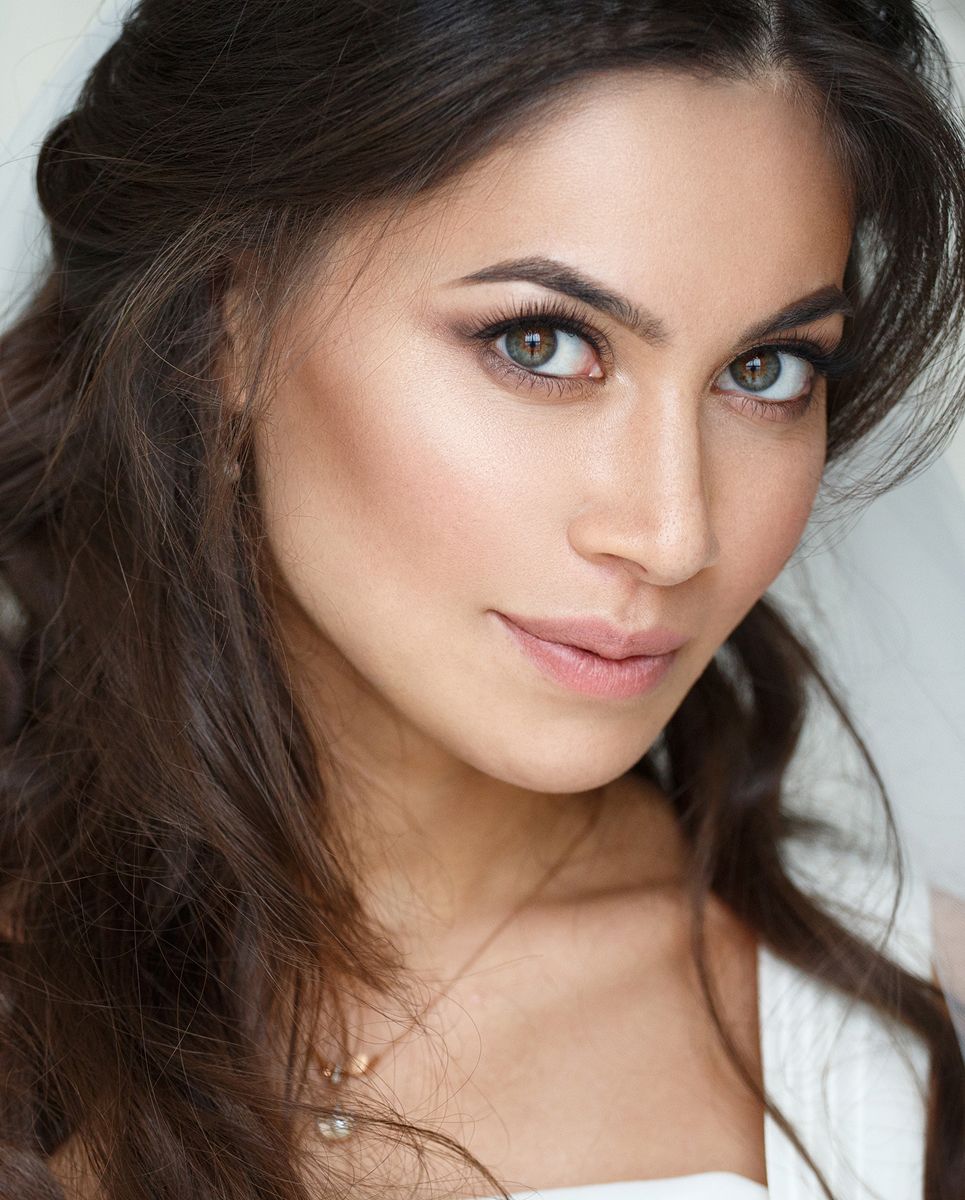 Woman with glamorous makeup and flowing hair.