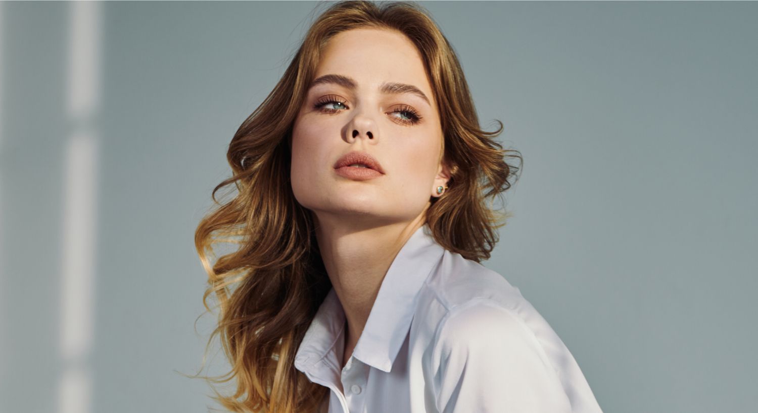 Woman with closed eyes and wavy hair.