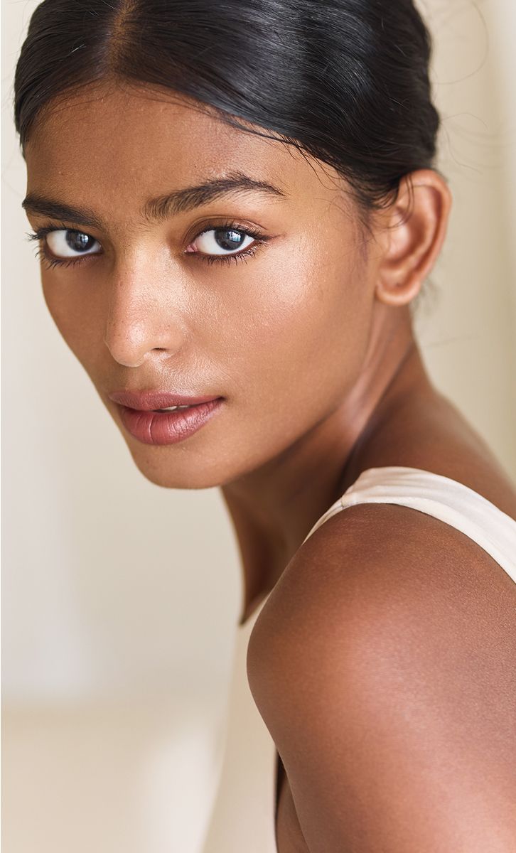 Close-up portrait of a woman with dark hair.