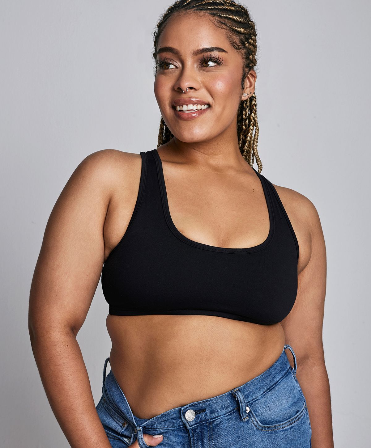 Smiling woman wearing a black crop top.