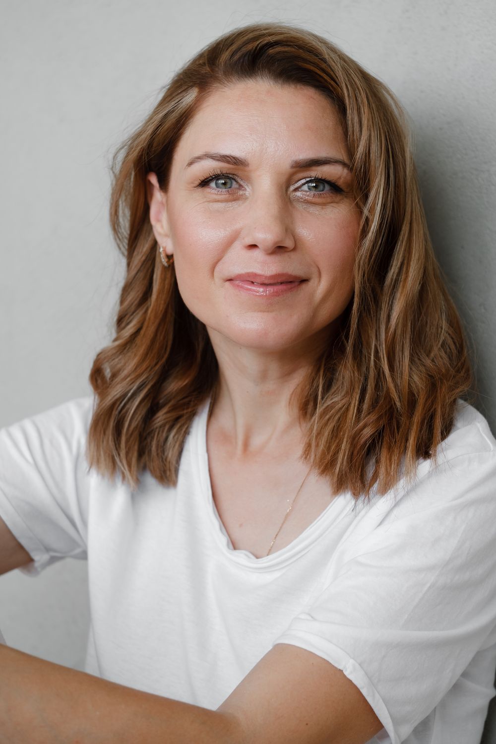 Close-up portrait of a woman with wavy hair.