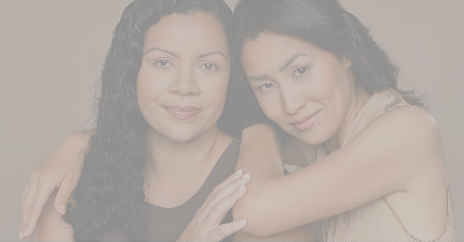 Two women smiling together in an embrace.