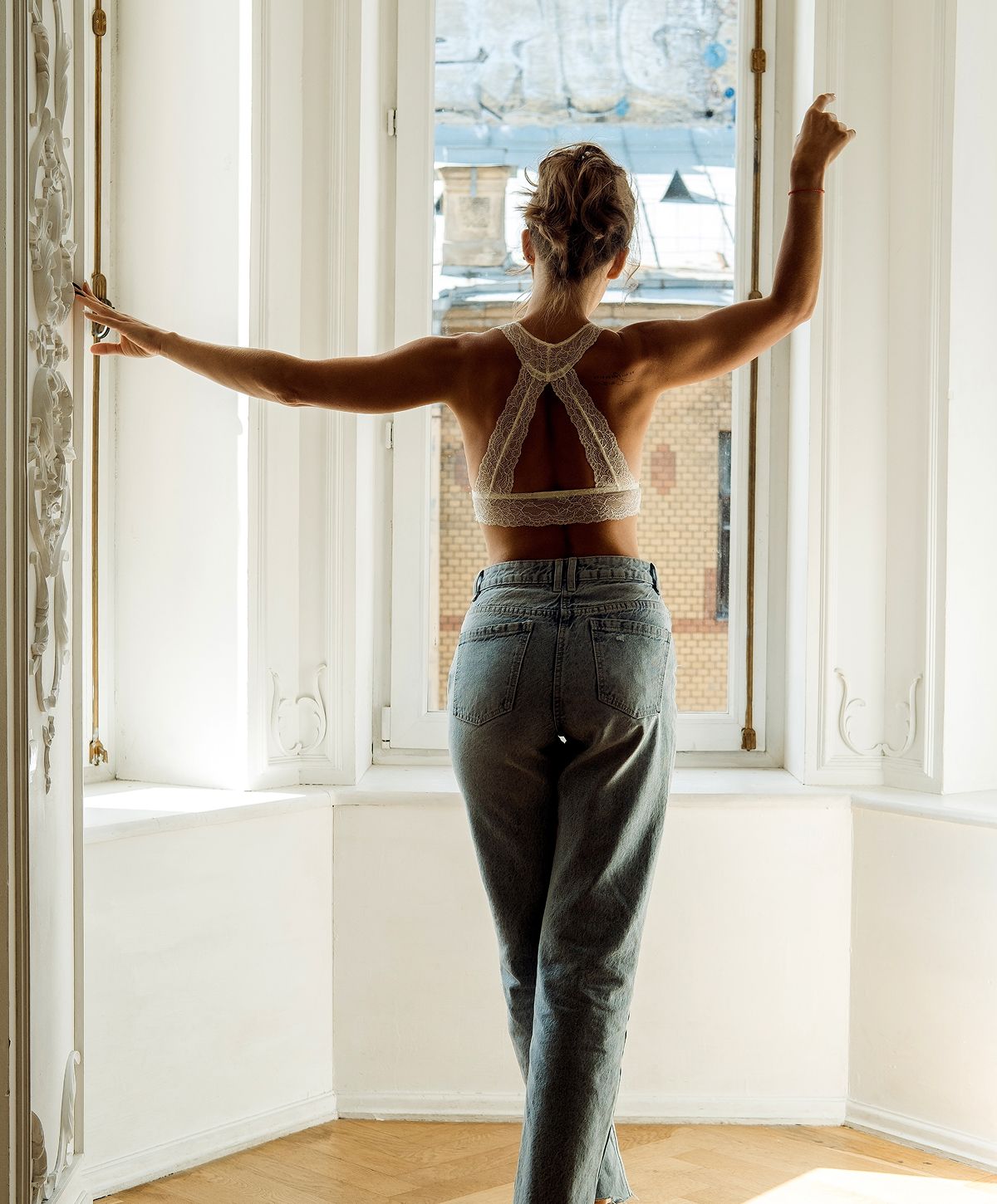 Model in casual lingerie setting indoors.