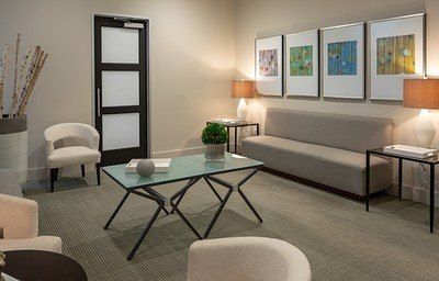 Modern, inviting waiting room with art and furniture.
