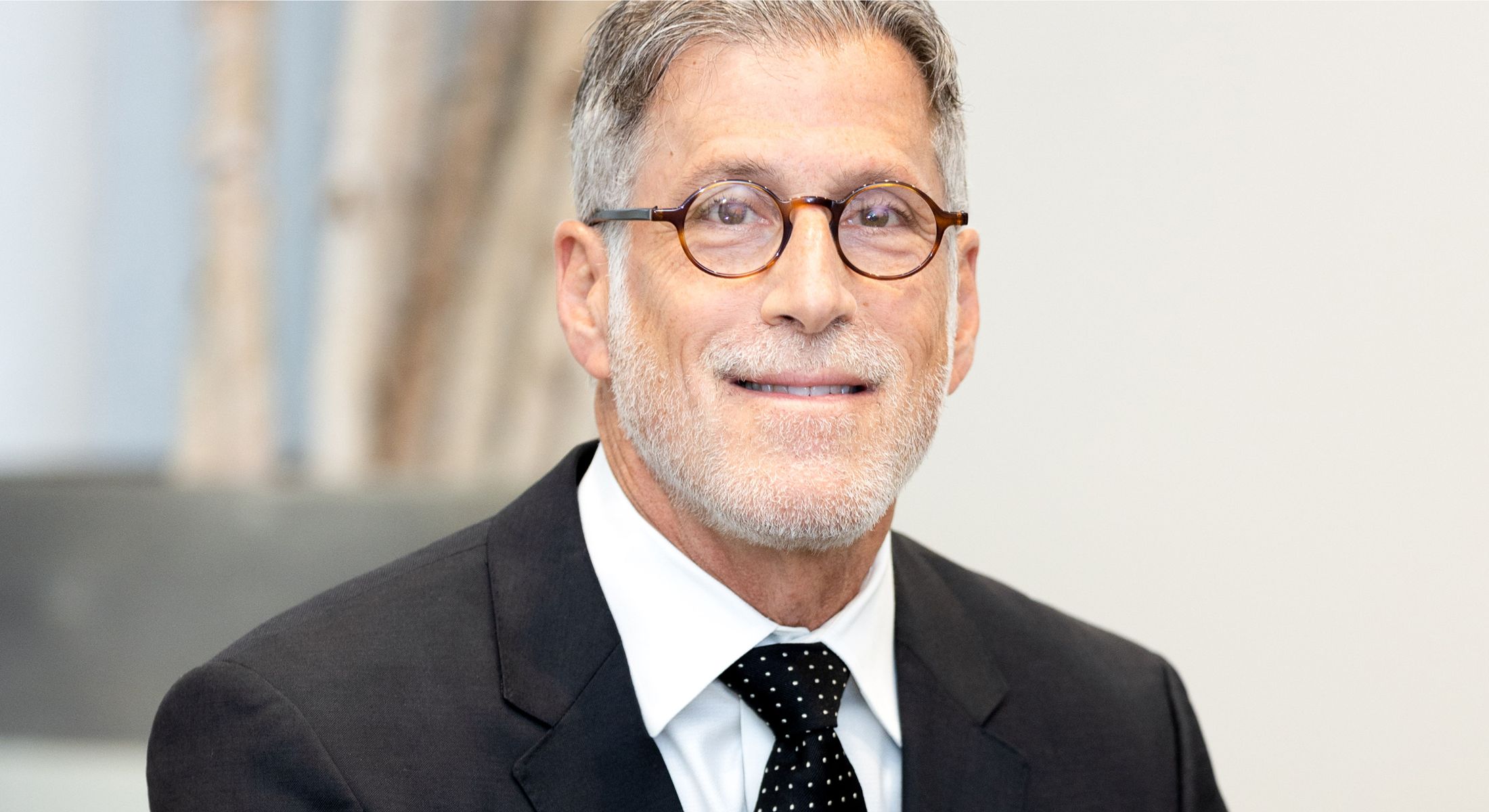 Businessman in a suit smiling at camera.
