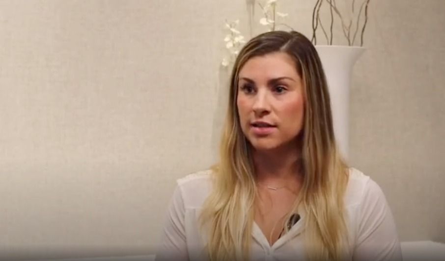 Person speaking in a brightly lit interview setting.