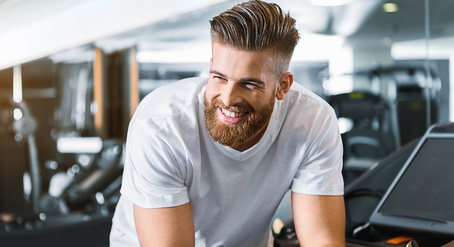 Smiling man in gym, fitness enthusiast portrait.
