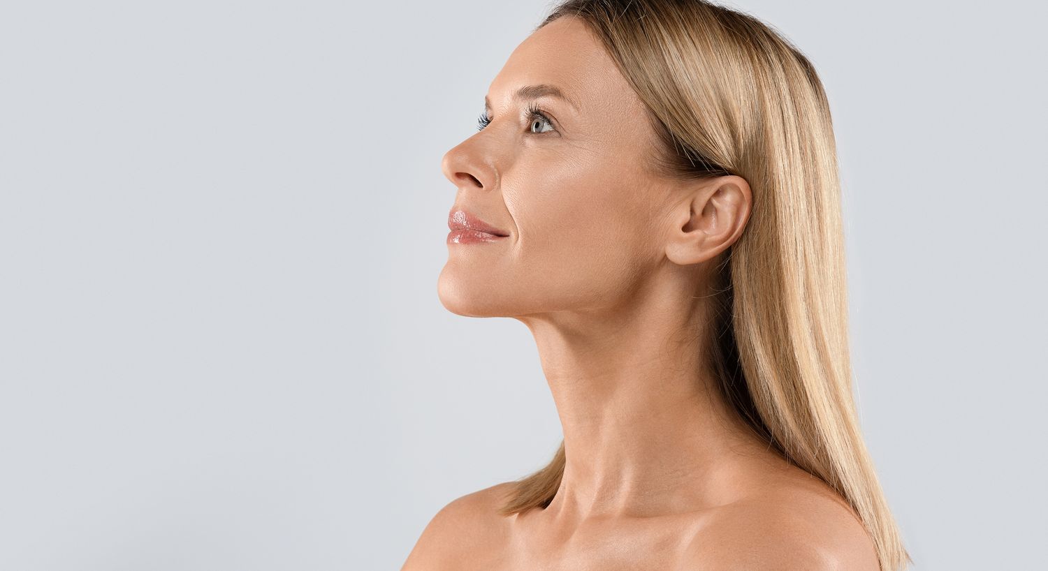 Profile view of a woman with smooth skin.